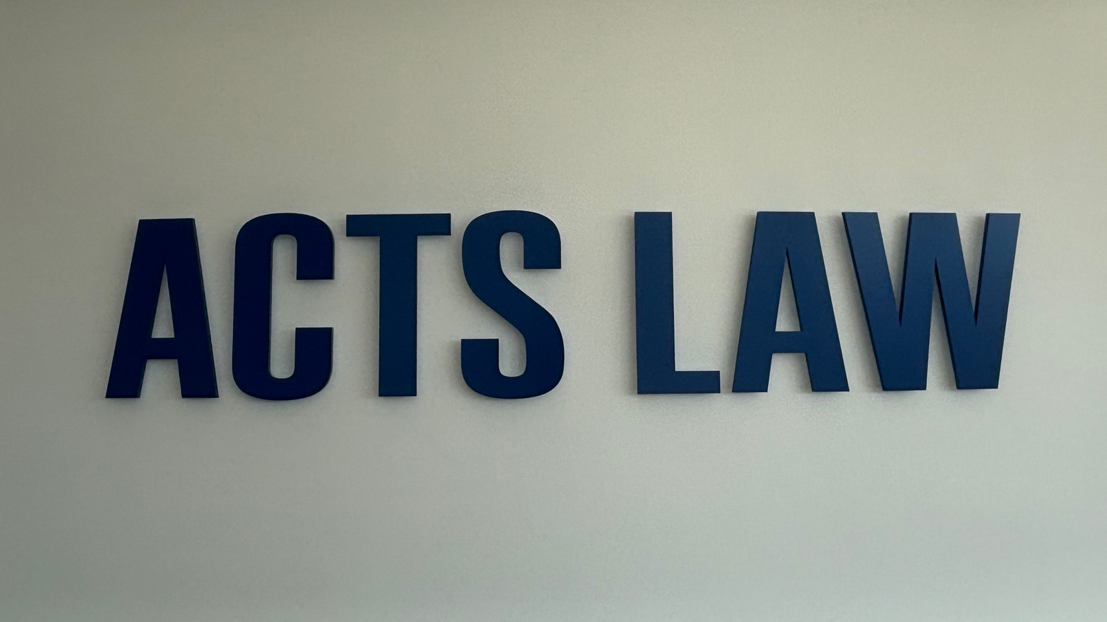 acts law painted acrylic letters on curved office wall