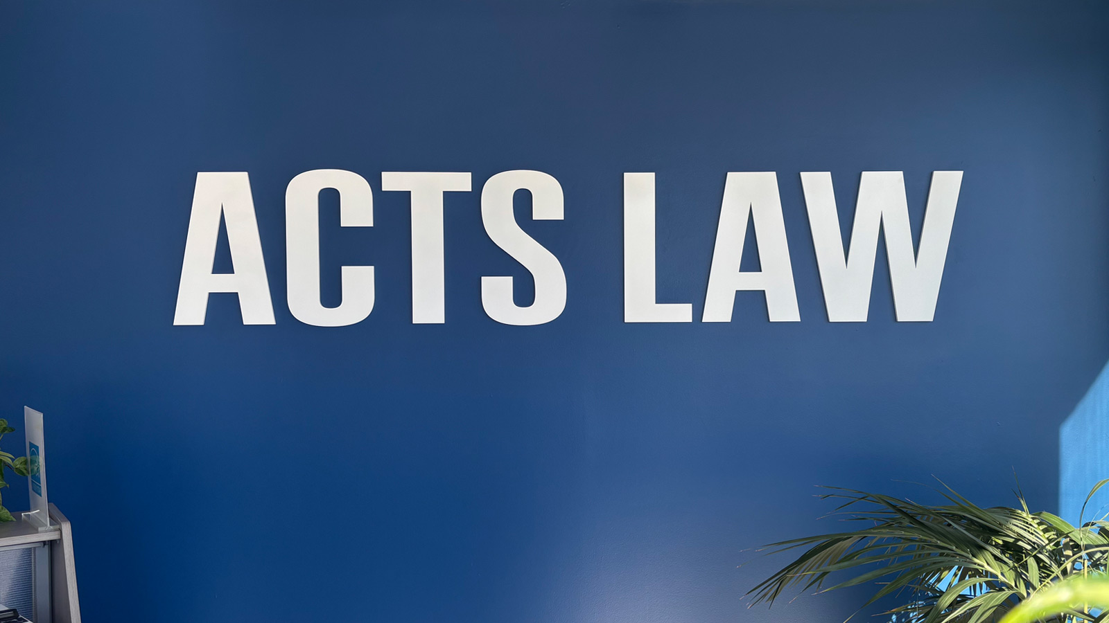 acts law painted acrylic letters on interior wall