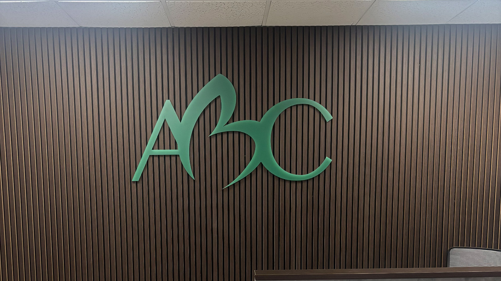 addiction best care acrylic logo on lobby wood slat wall