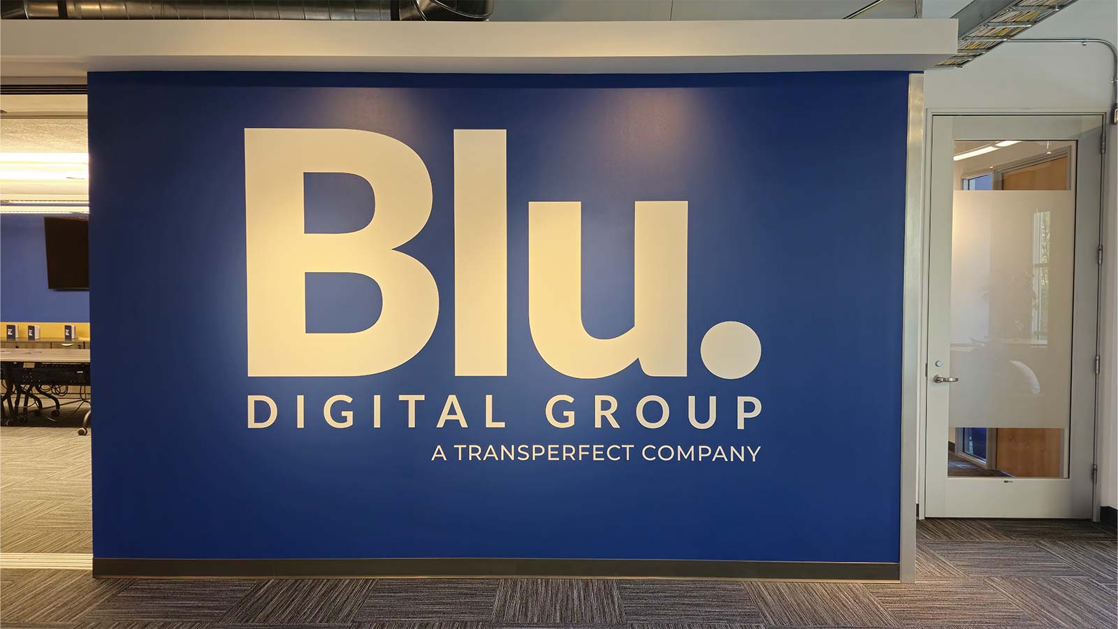 blu digital group vinyl lettering on the lobby wall