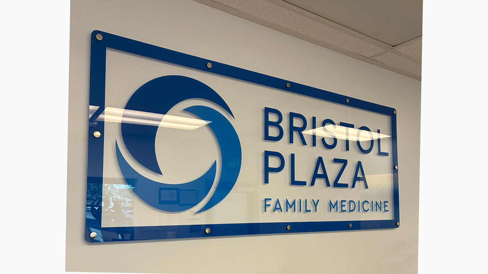 bristol plaza acrylic wall sign mounted on office wall