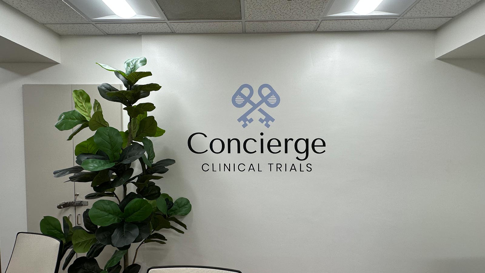 concierge clinical trials logo display mounted on wall