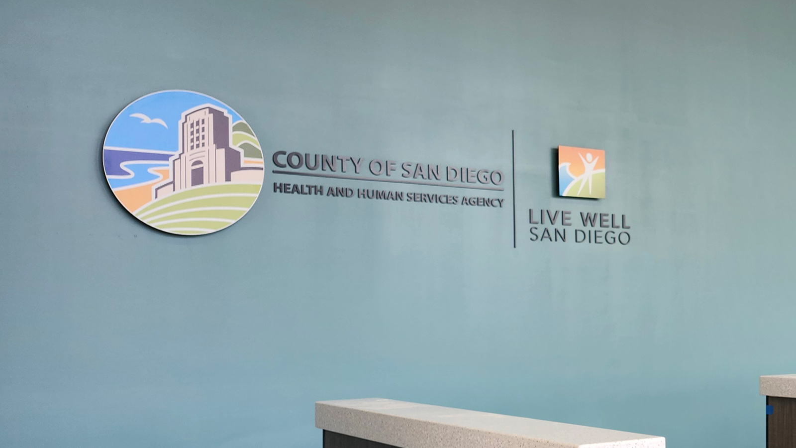 county of san diego hhsa lobby sign mounted on wall
