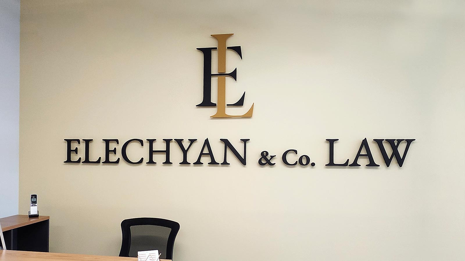 elechyan and co law acrylic letters and logo on office wall