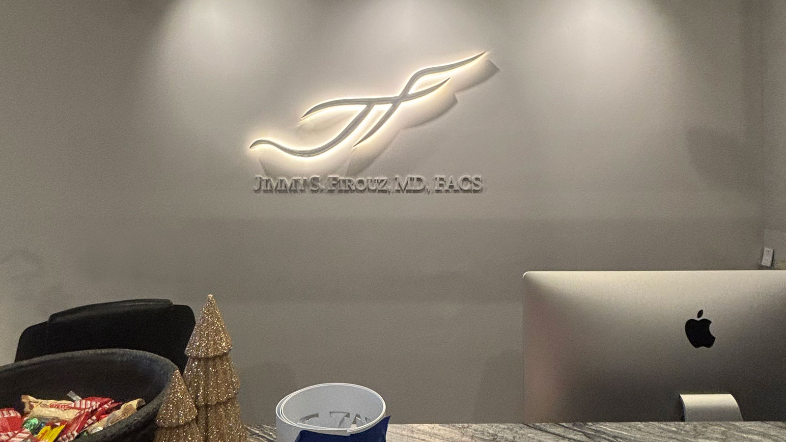 firouz institute back-lit logo sign on office lobby wall