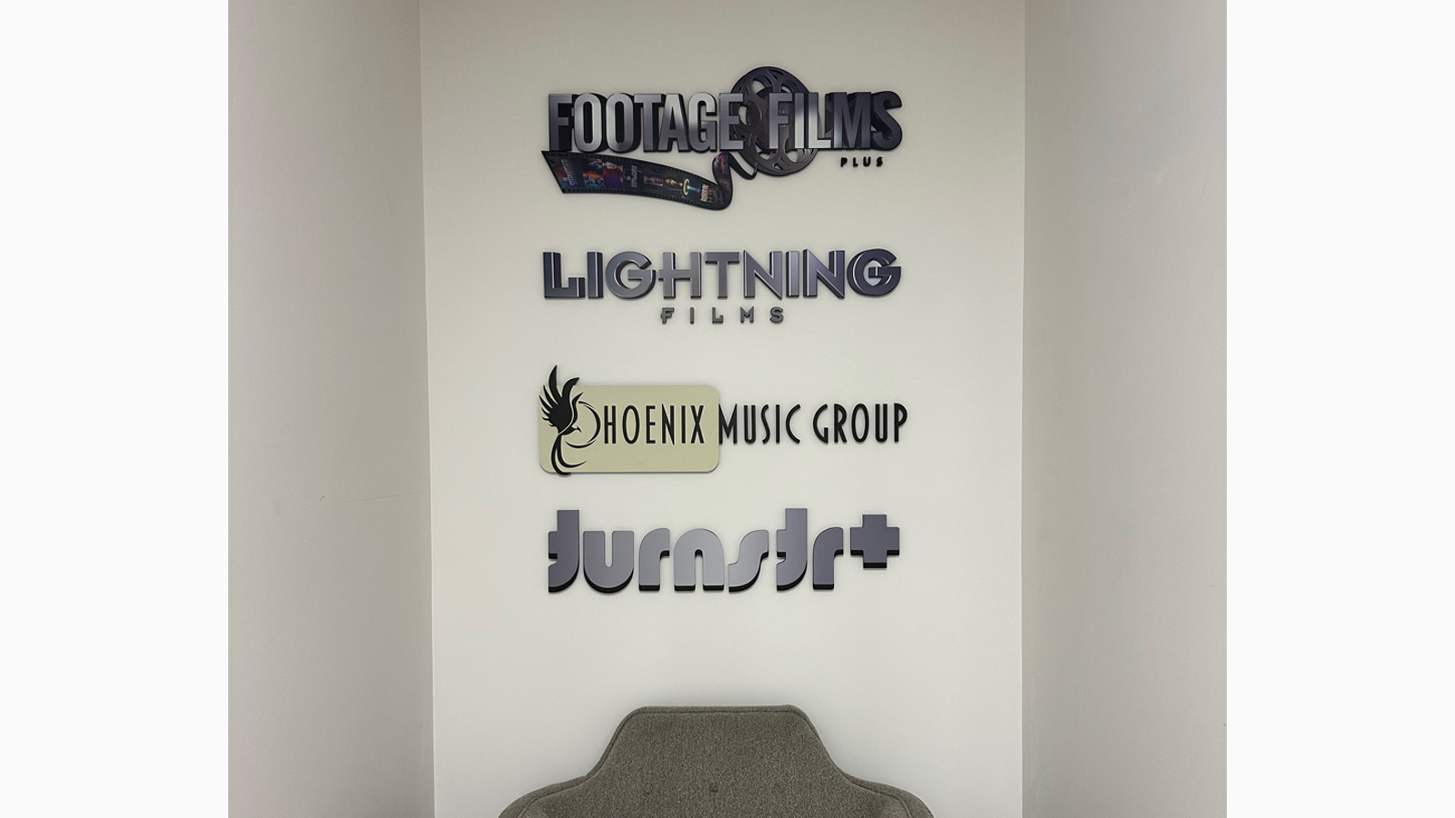 footage films studios acrylic brand signs on office wall