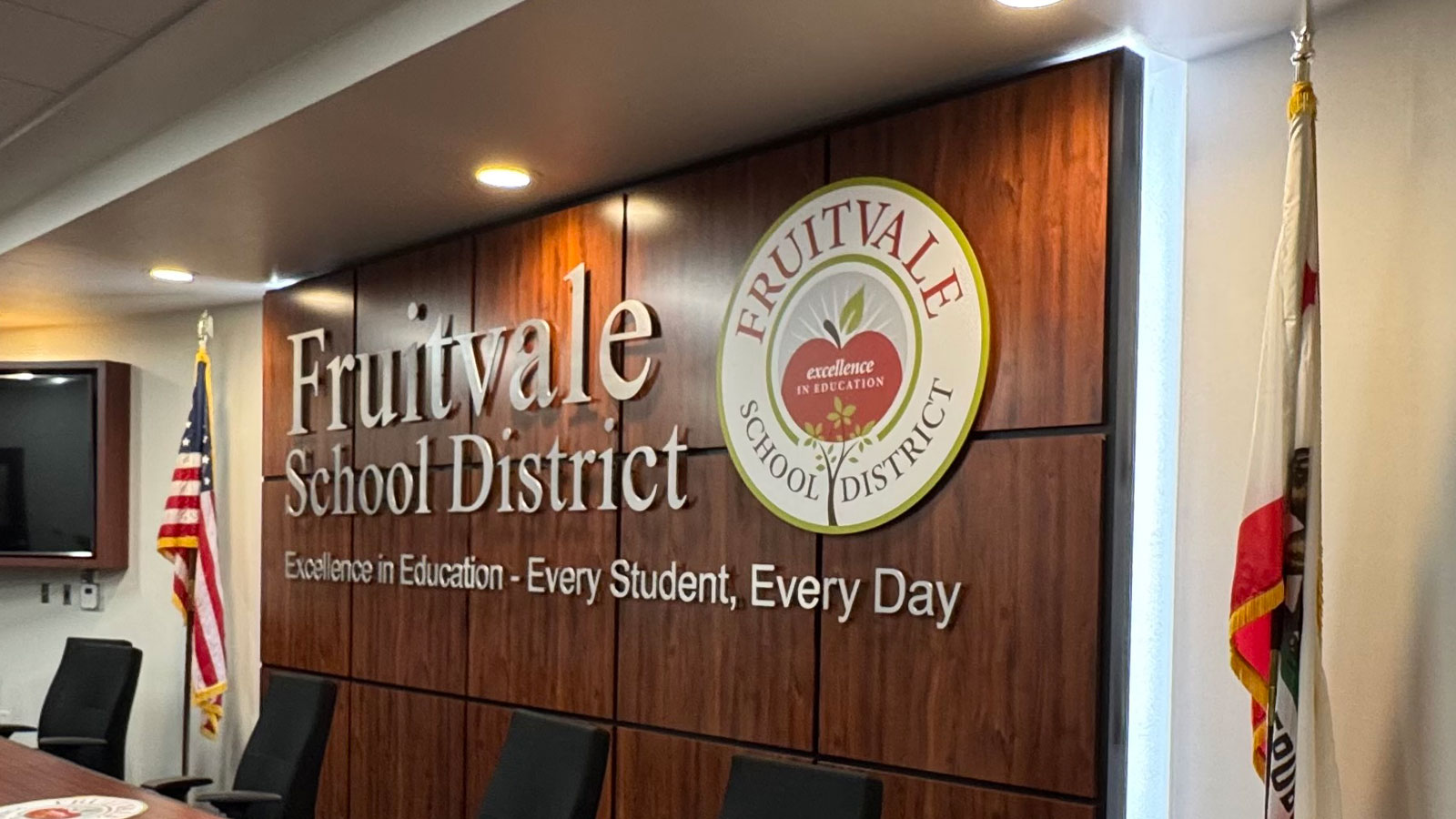fruitvale school district sign mounted on boardroom wall
