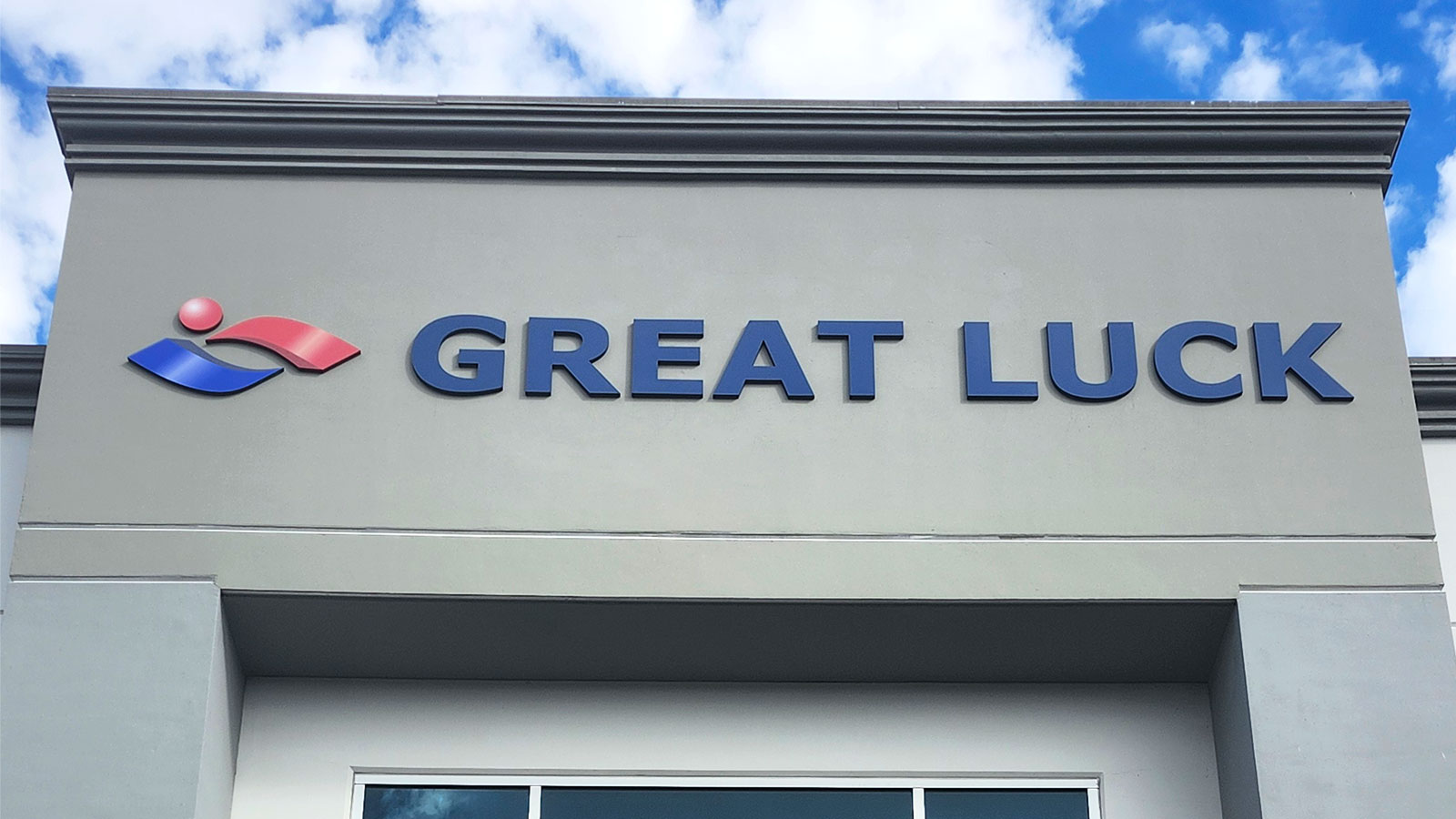 great luck pvc letters and logo mounted on building wall