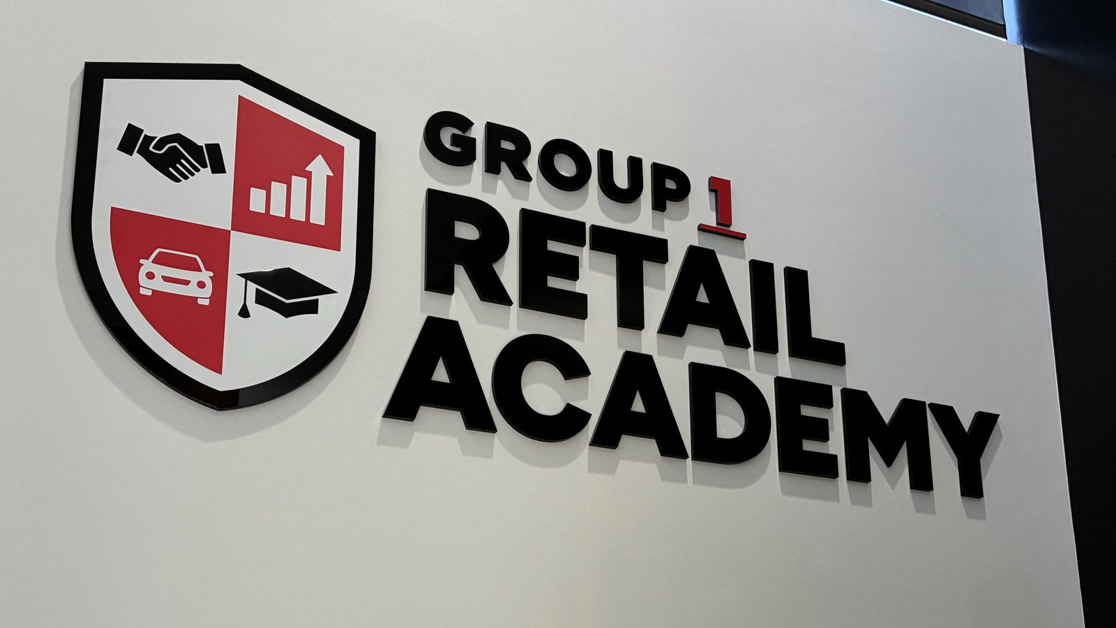 group 1 retail academy dimensional sign mounted on wall