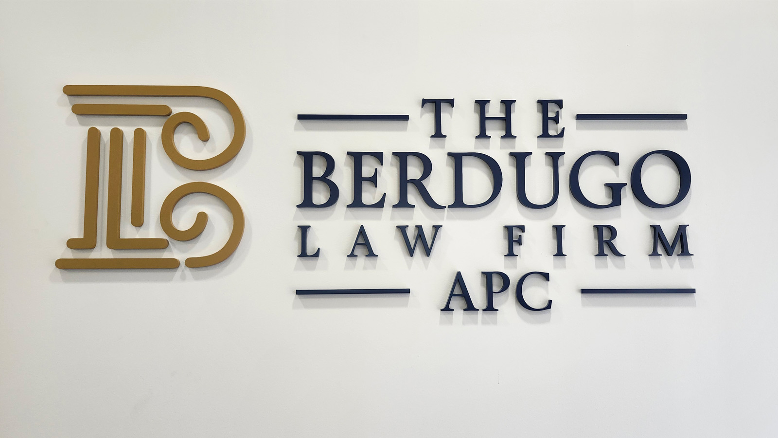 he berdugo law firm acrylic sign mounted on reception