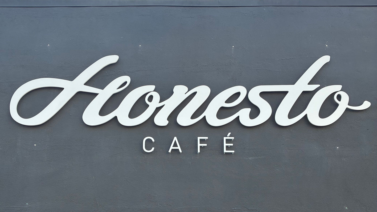 honesto cafe acrylic letters mounted on storefront wall