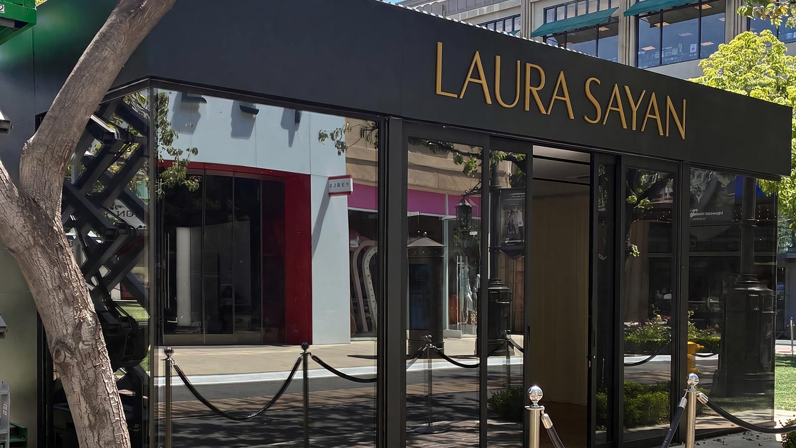 laura sayan storefront sign installed on retail facade