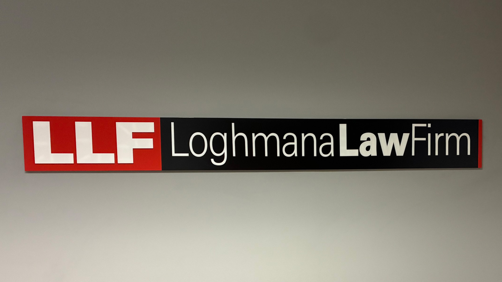 loghmana law firm acrylic sign mounted on reception wall