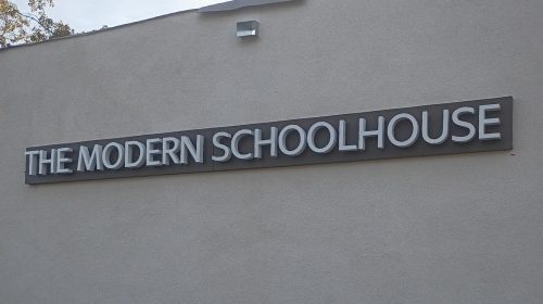 modern schoolhouse back lit channel letters on building wall