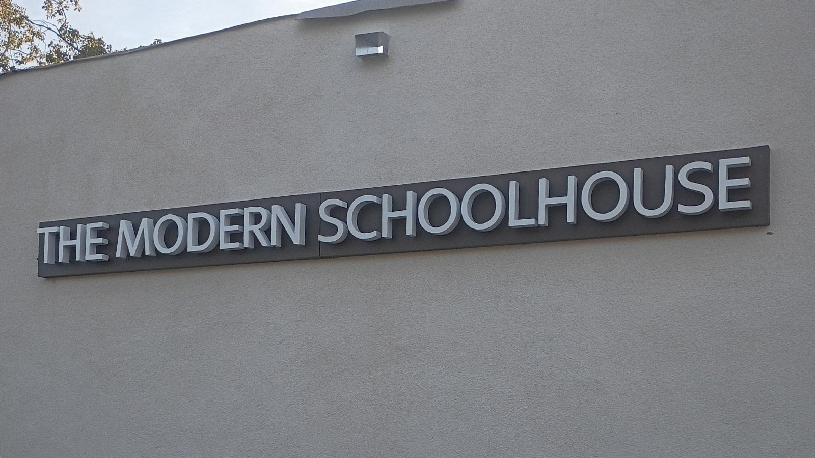 modern schoolhouse back lit channel letters on building wall