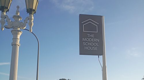 modern schoolhouse double sided sign mounted on post