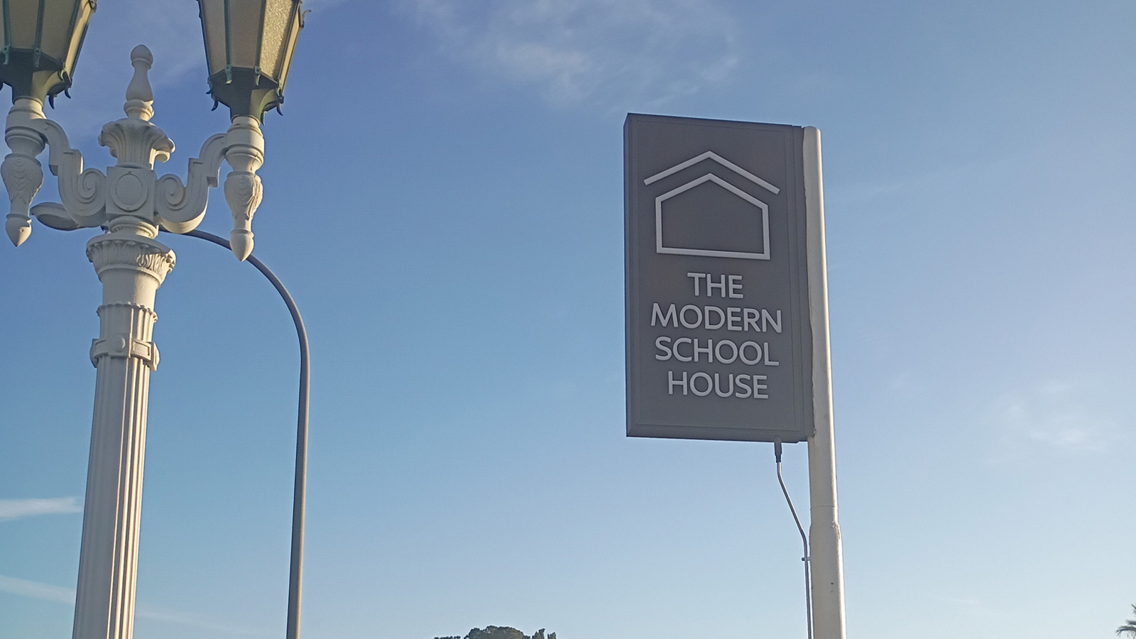 modern schoolhouse double sided sign mounted on post