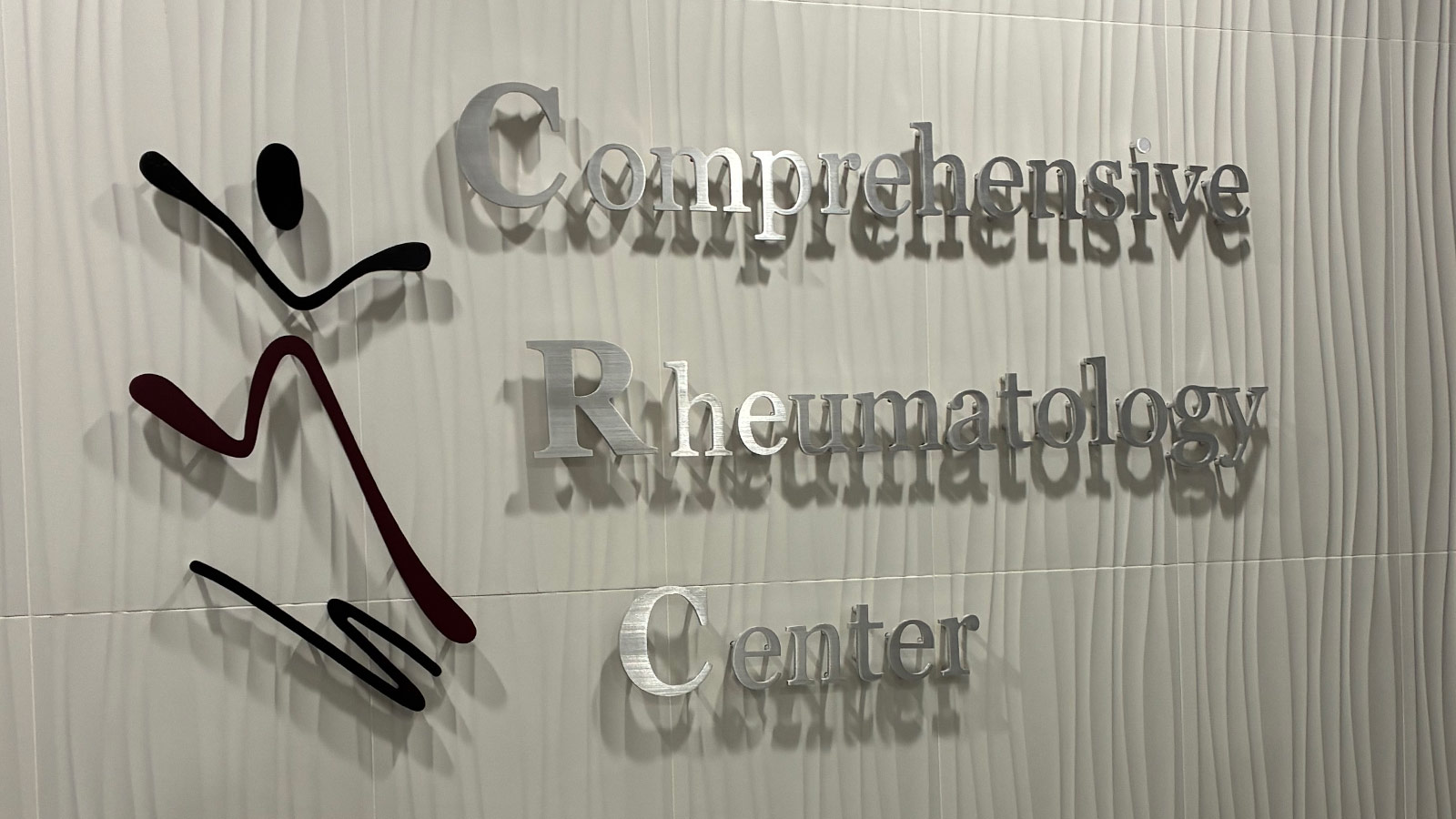 nazanin firooz md brushed aluminum sign mounted on wall