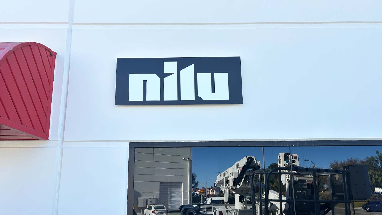 nilu27 aluminum composite panel sign mounted on building