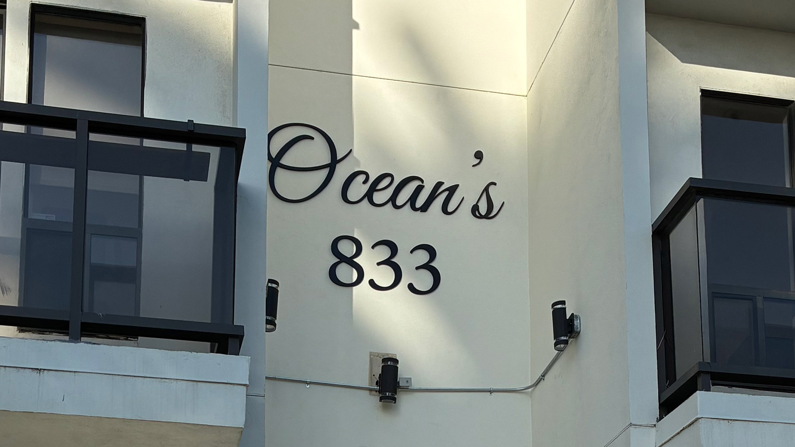 oceans 833 acrylic cutout sign mounted on entrance wall