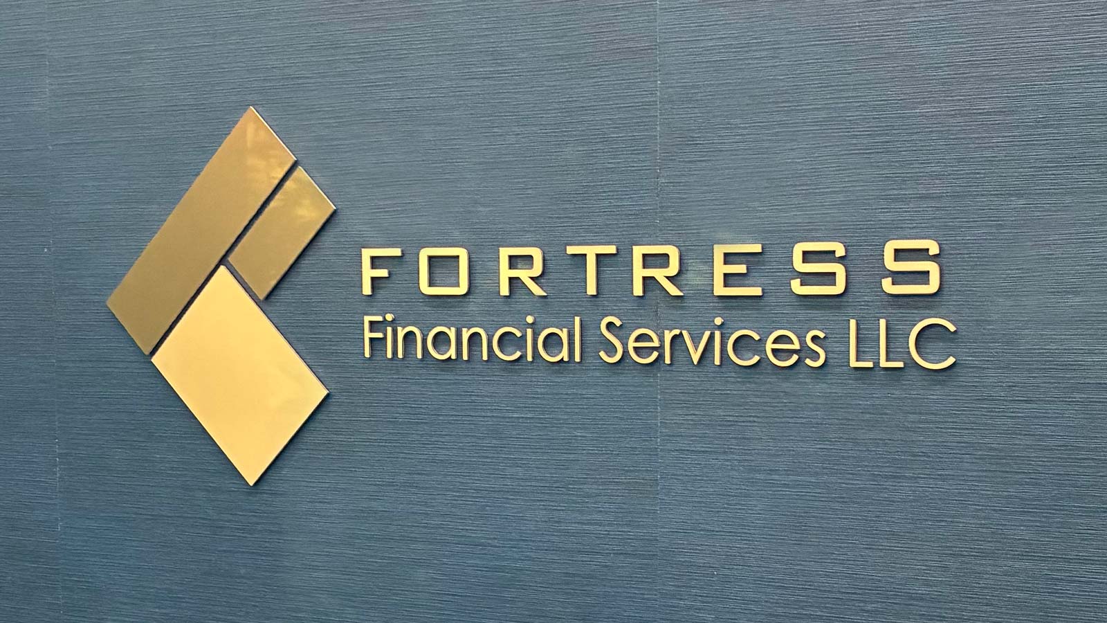ortress financial services gold letters on office wall