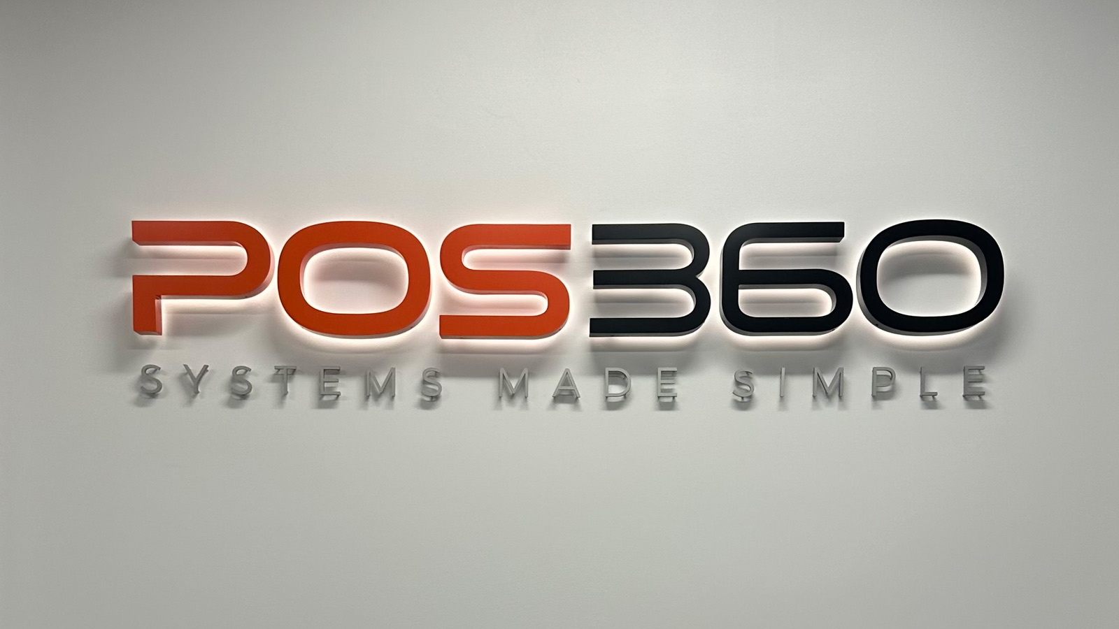 pos360 halo lit reception sign mounted on the wall