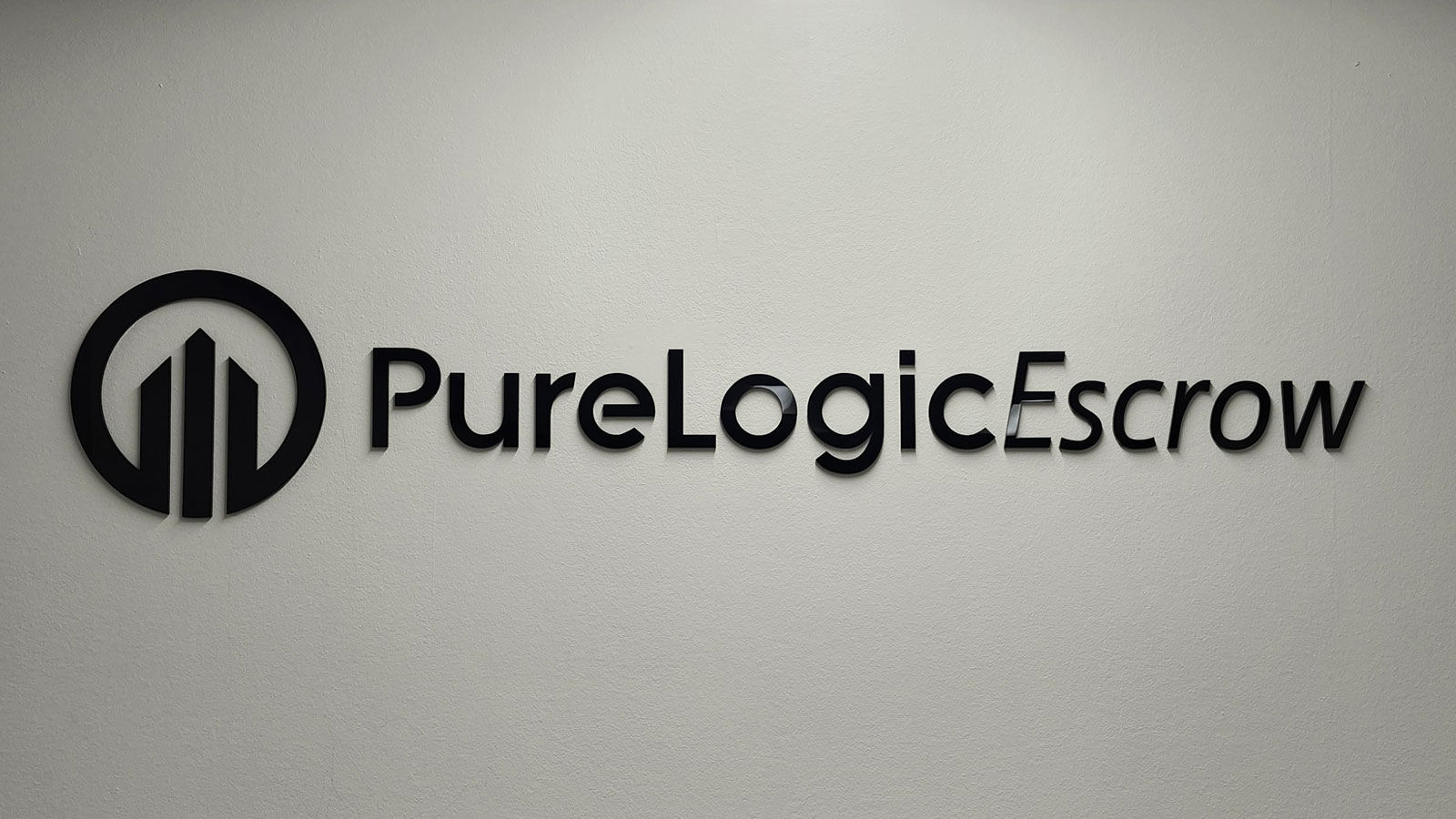 pure logic escrow acrylic sign reinstalled at new office