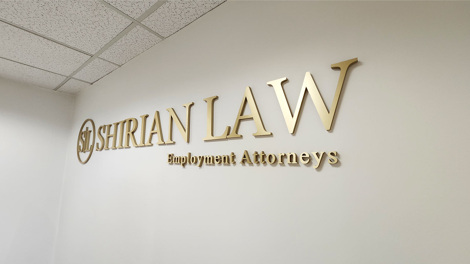 shirian law brushed gold acrylic letters on office wall