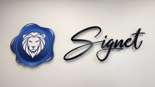 signet capital group acrylic logo mounted on office wall