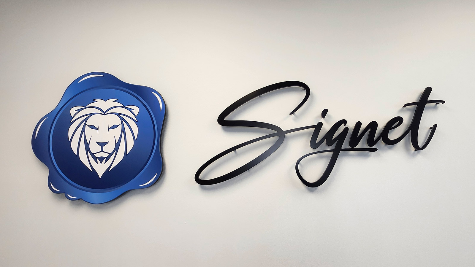 signet capital group acrylic logo mounted on office wall