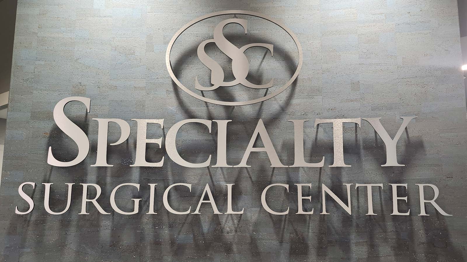 specialty surgical center acrylic sign on lobby wall