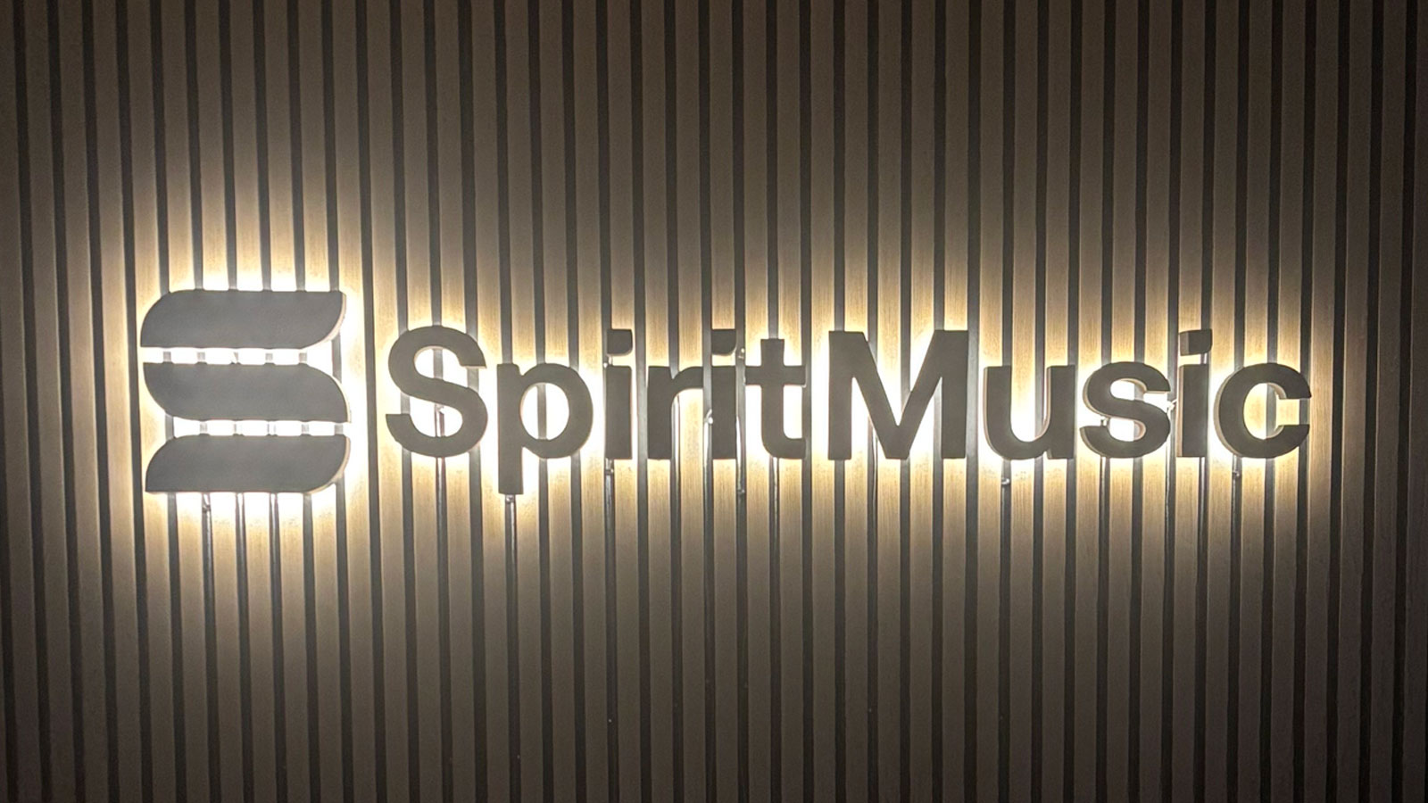 spirit music group back-lit reverse letters on wood wall