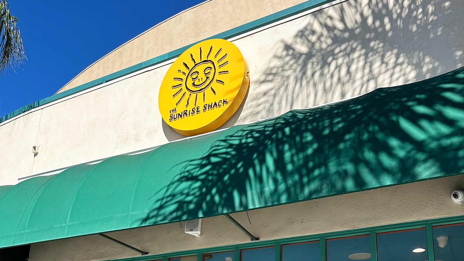 sunrise shack round illuminated cabinet sign on storefront