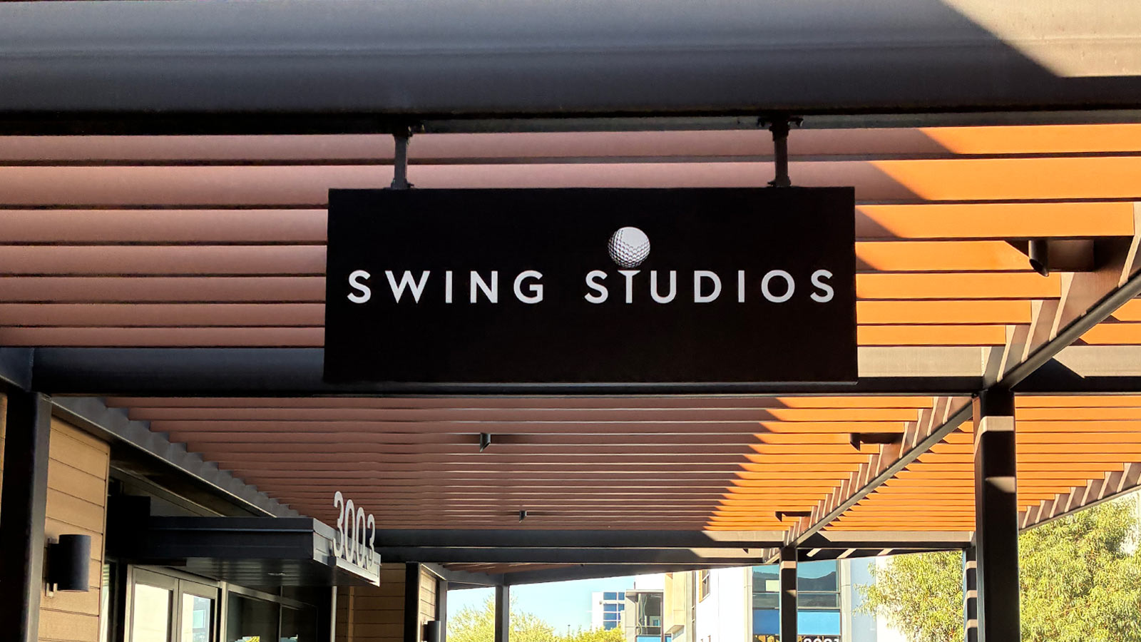 swing studios vinyl blade sign mounted on storefront