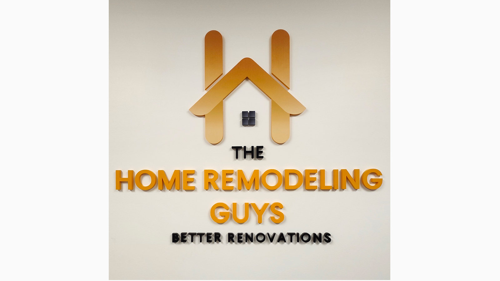 the home remodeling guys acrylic logo on office wall