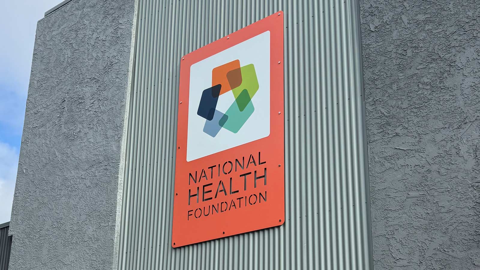 totum painted aluminum panel sign mounted on storefront