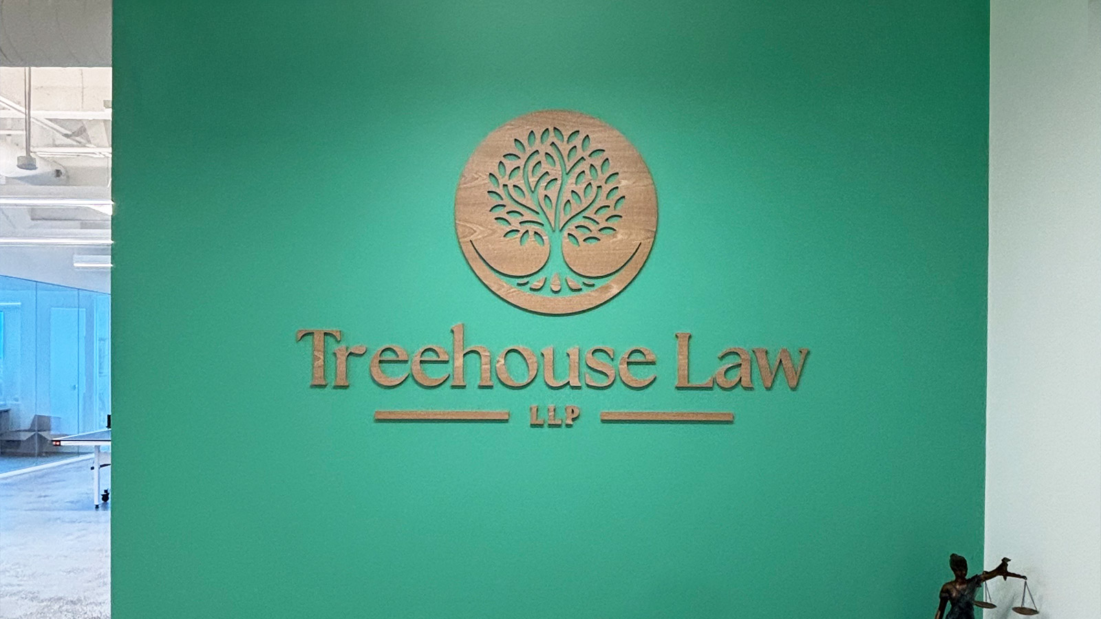 treehouse law llp wood logo mounted on office wall