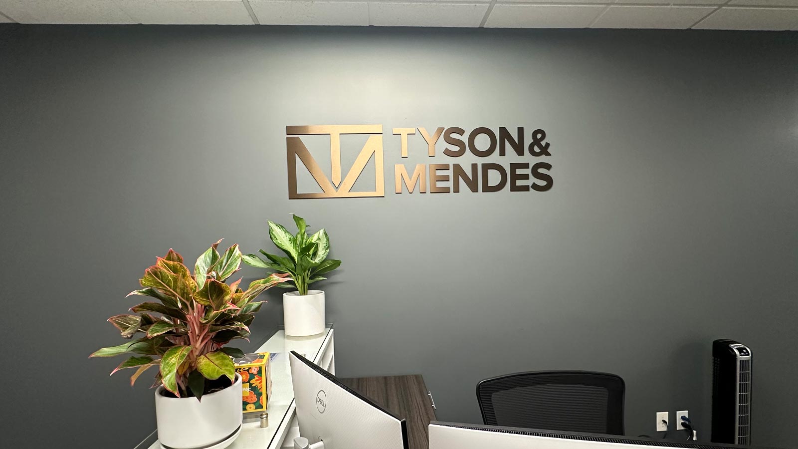 tyson and mendes bronze acrylic letters on office wall