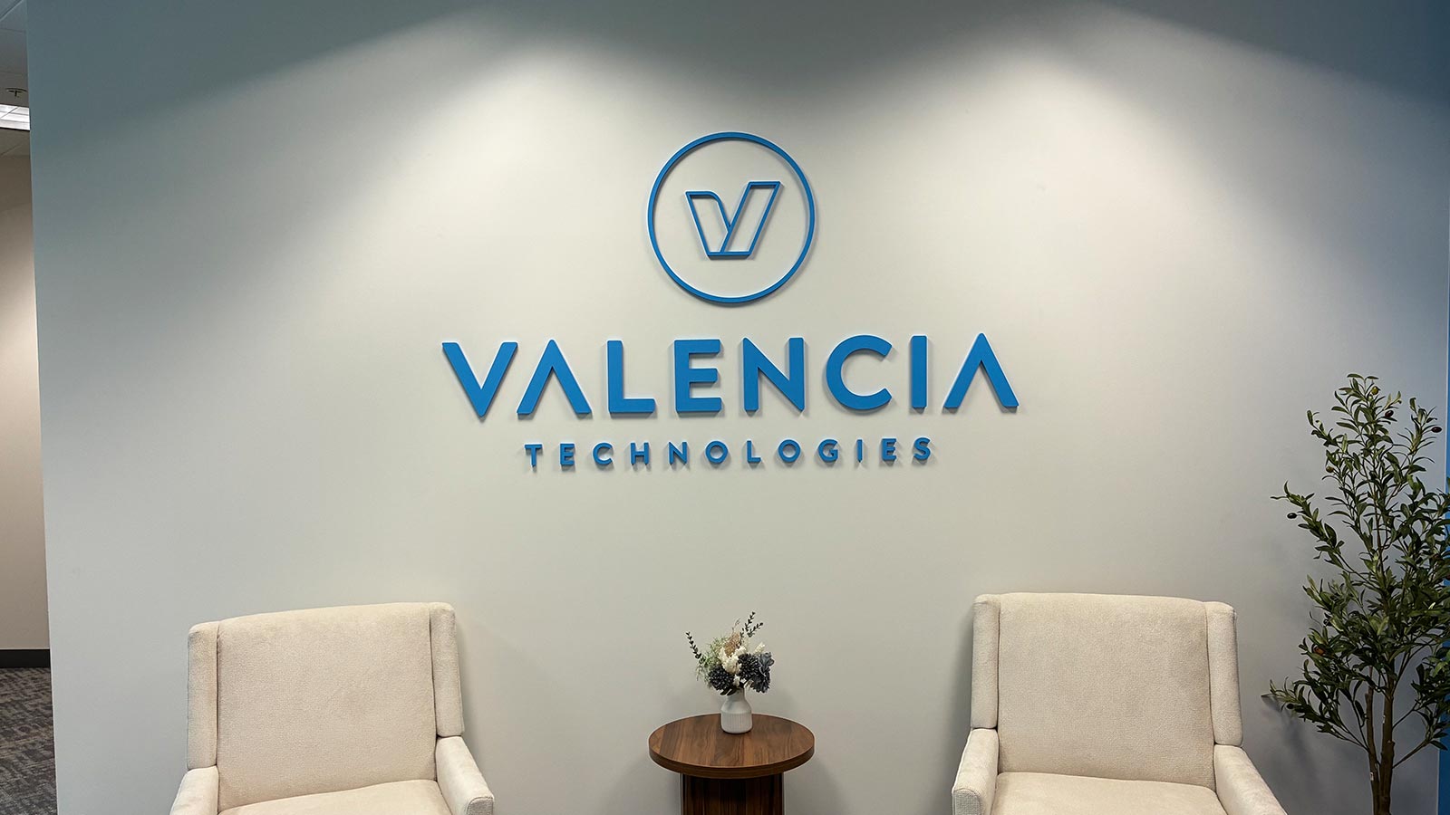 valencia technologies acrylic signs mounted on office wall
