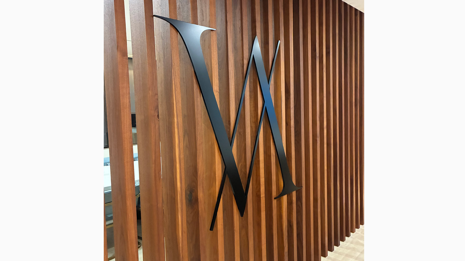 virtu global advisors logo cutout mounted on the wall
