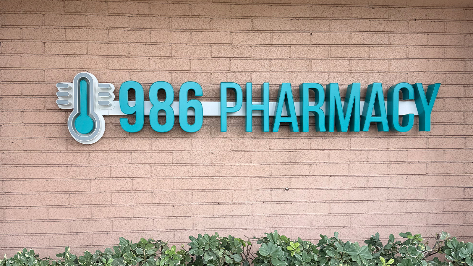986 pharmacy teal channel letters on brick facade