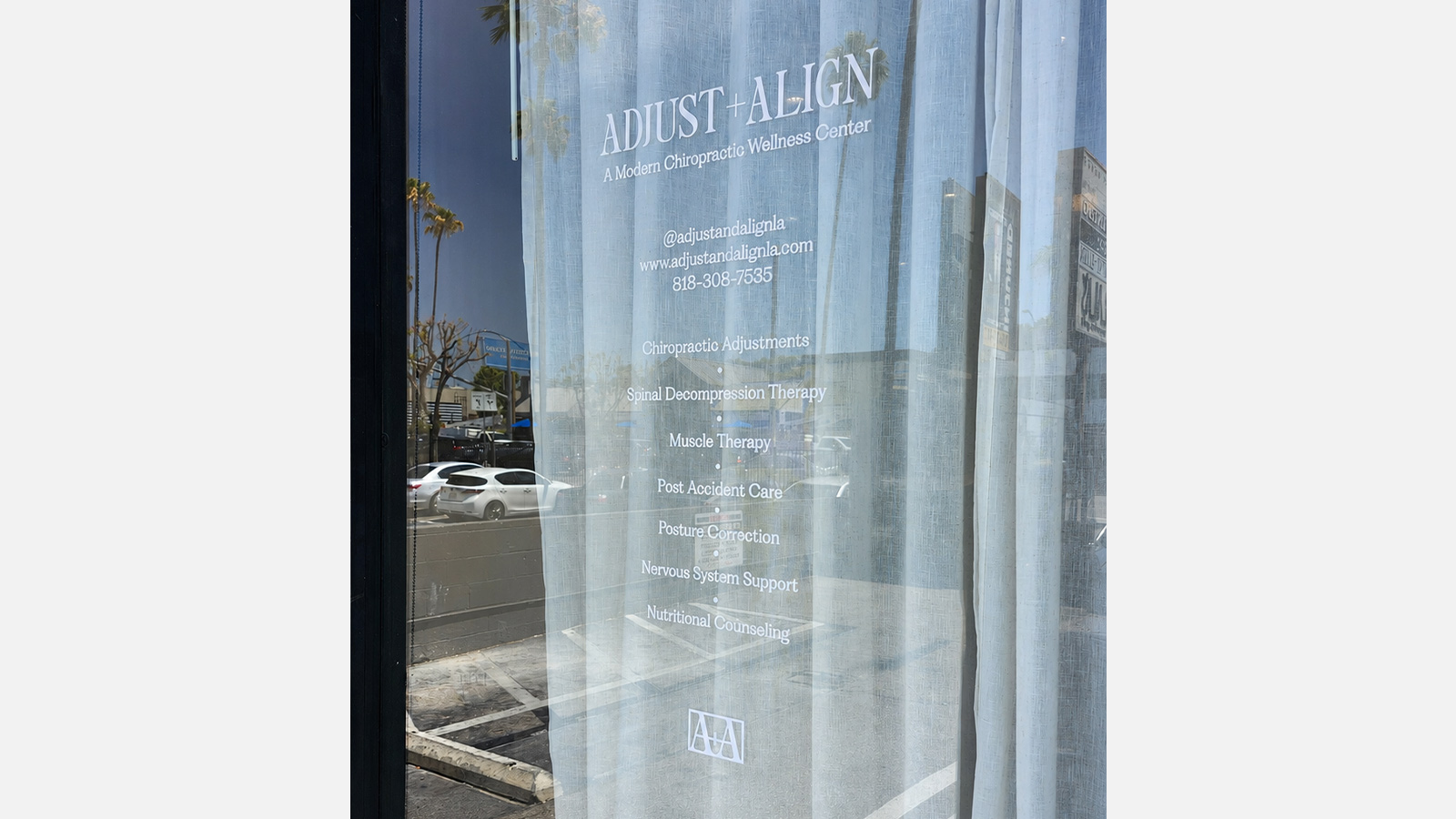 adjust and align white vinyl lettering on storefront window