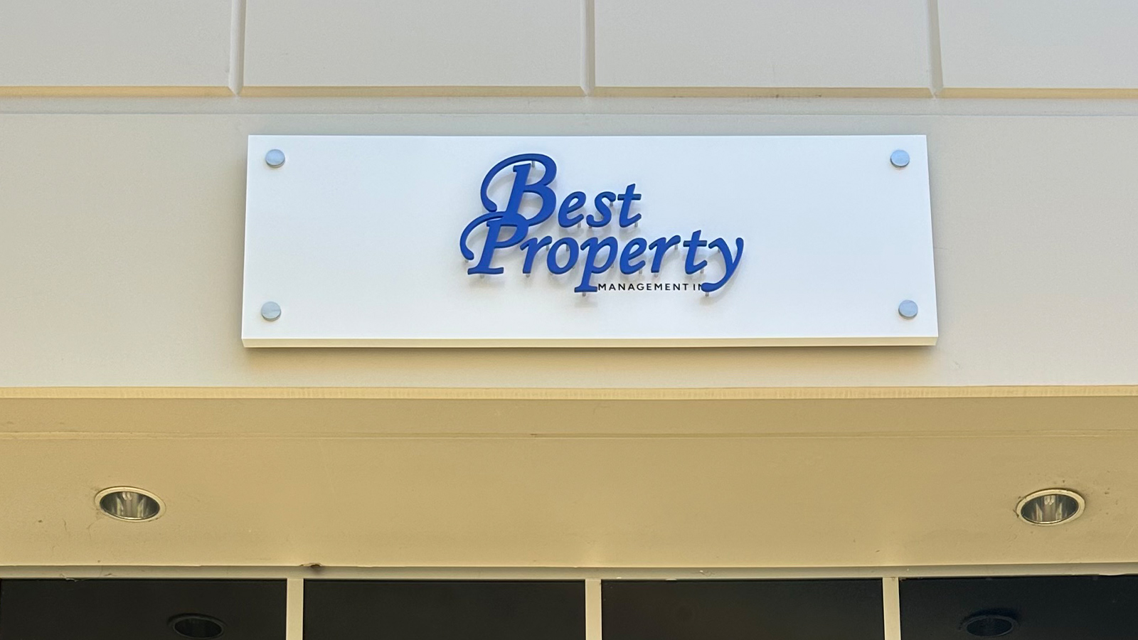 best property management aluminum sign above entrance