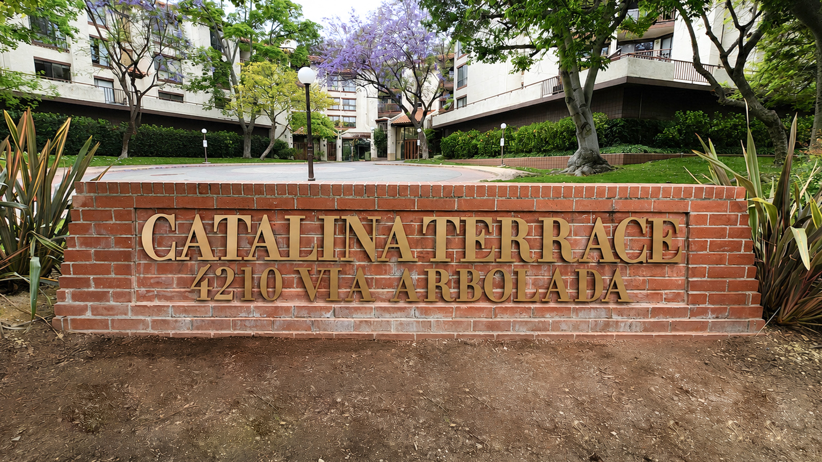catalina terrace hoa brass channel letters on brick wall