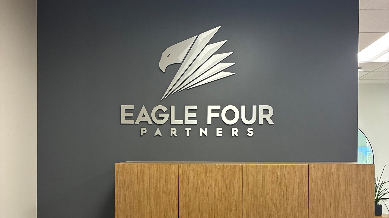 eagle four partners ultraboard logo sign on lobby wall
