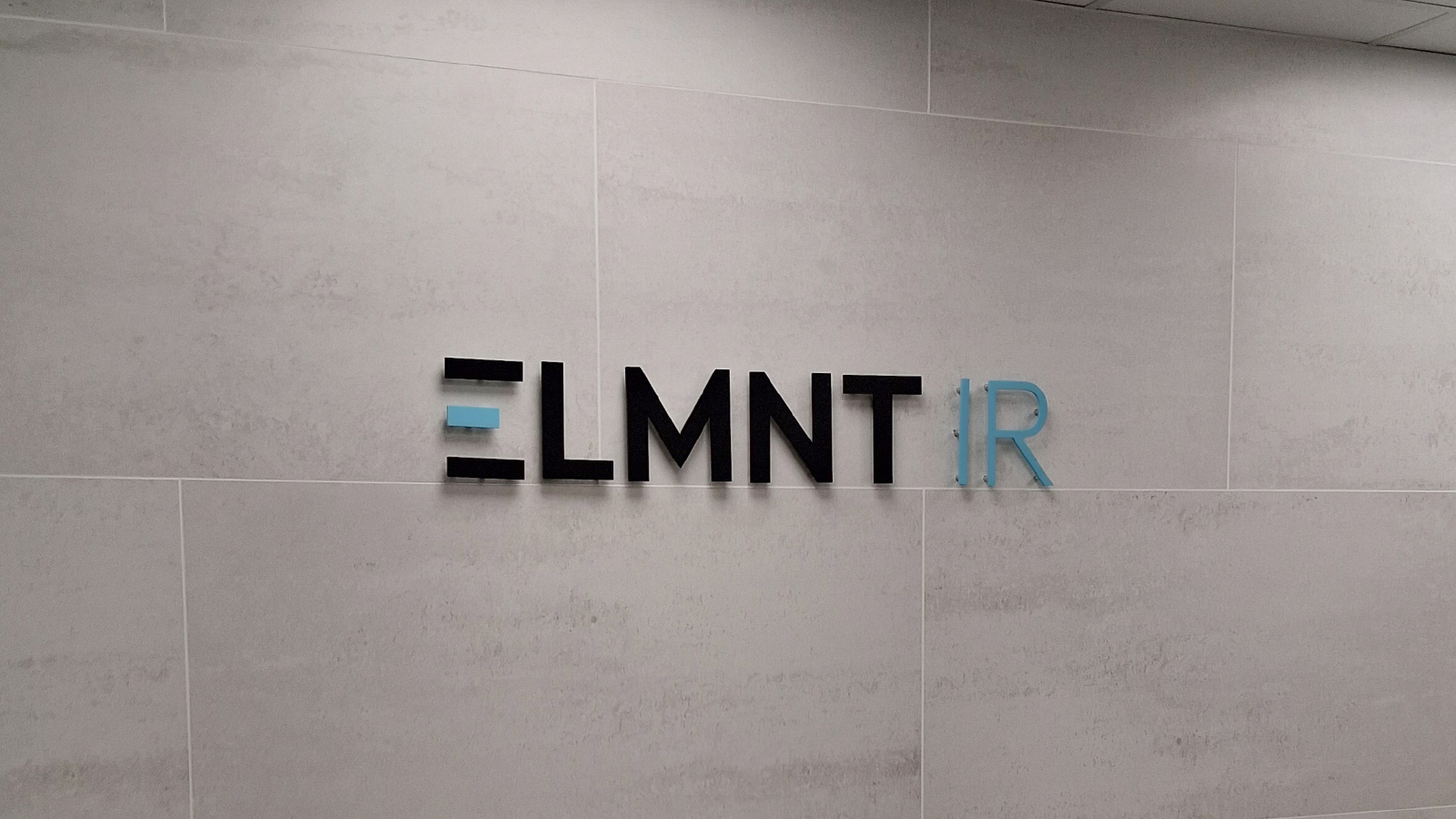 elmnt ir acrylic letters on tile wall