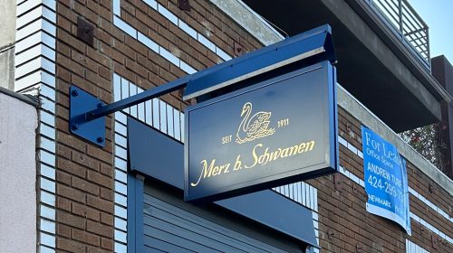 merz b schwanen blade sign on facade
