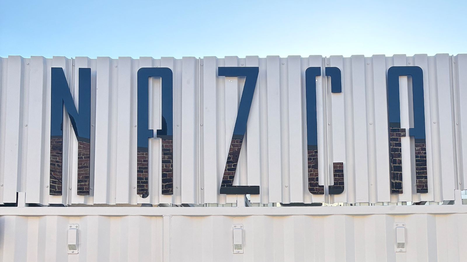 nazca fusion black acrylic letters on metal facade