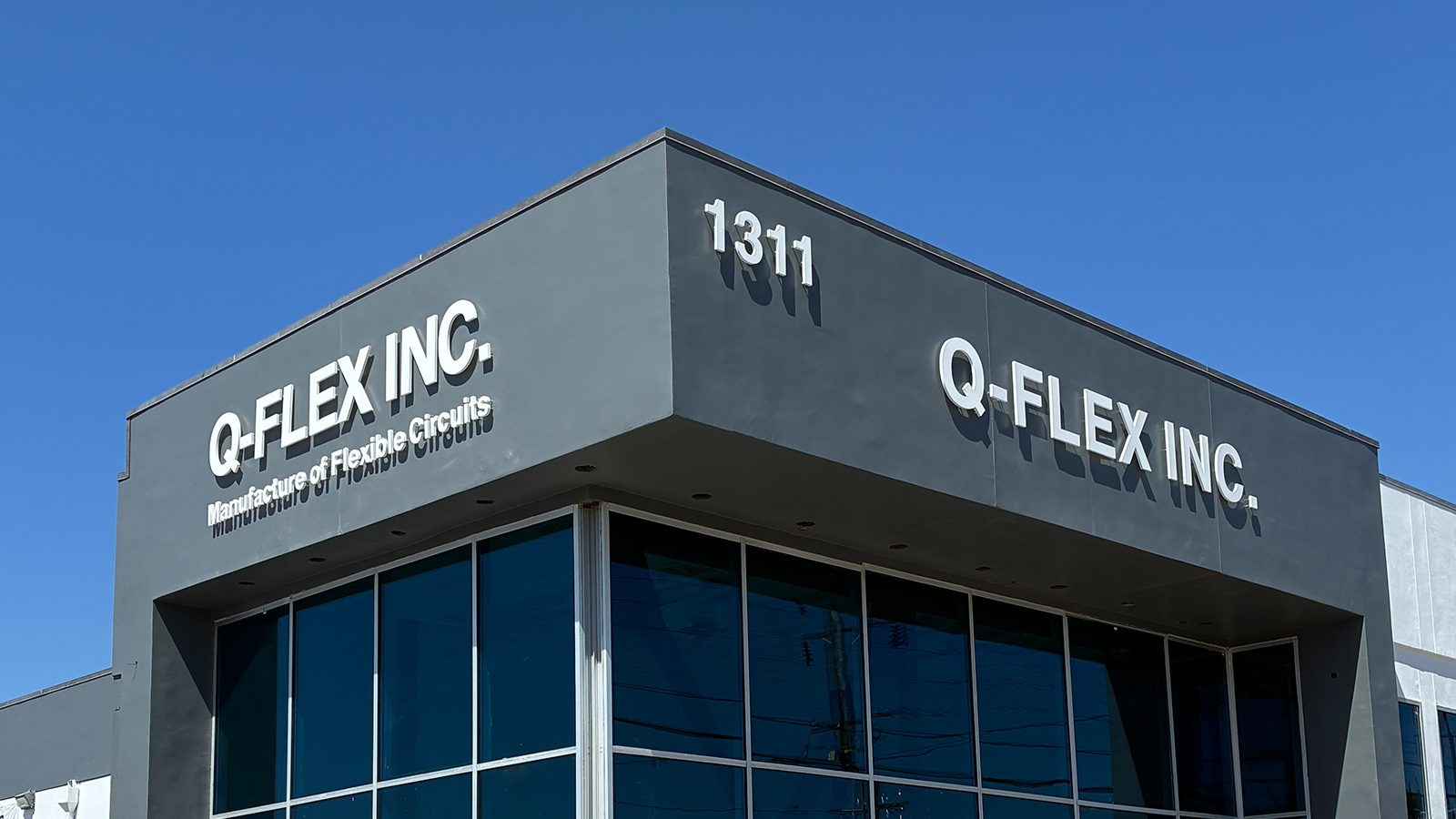 qflex inc white acrylic letters on building facade