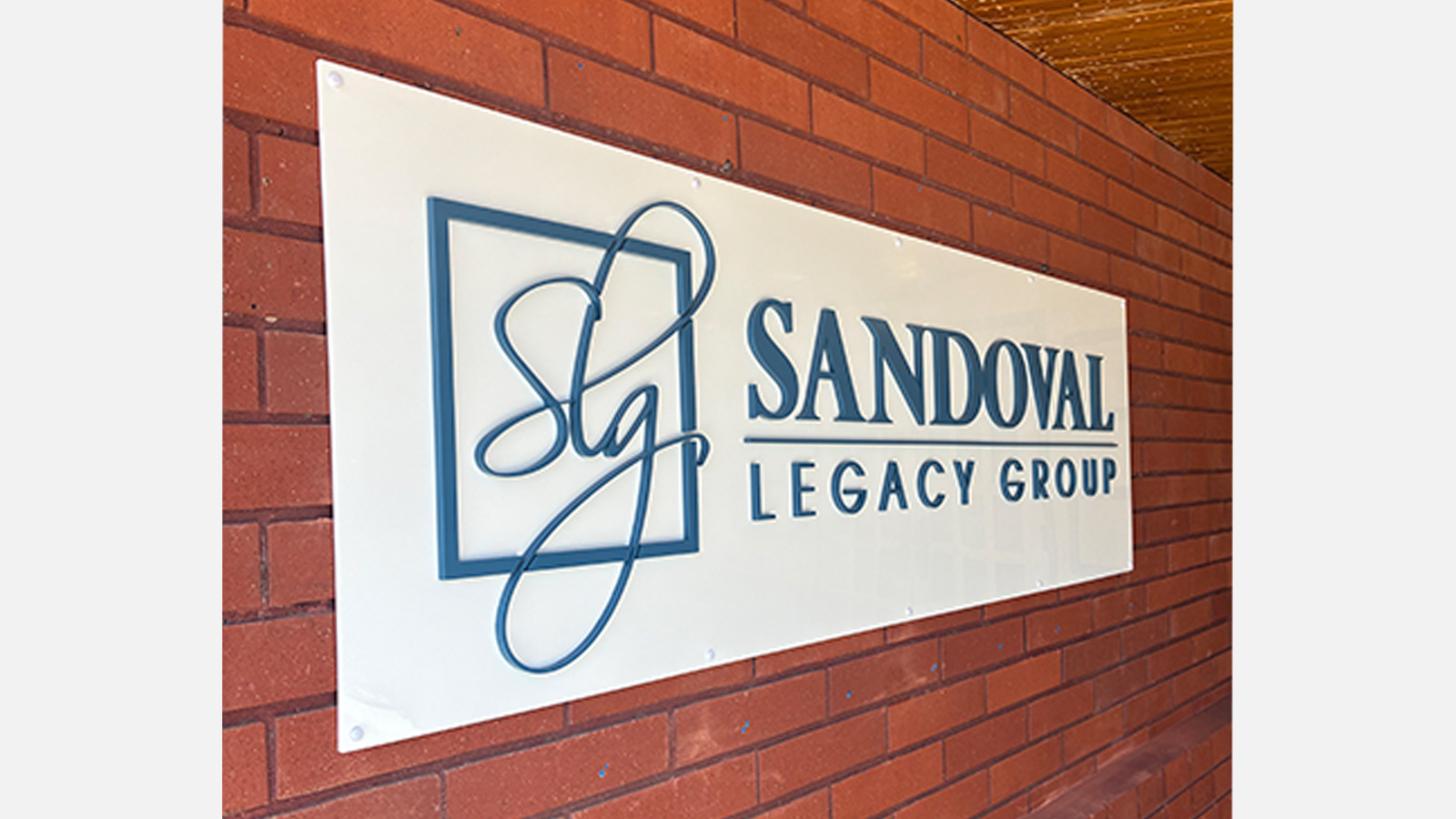 slg law firm white acrylic panel on brick wall